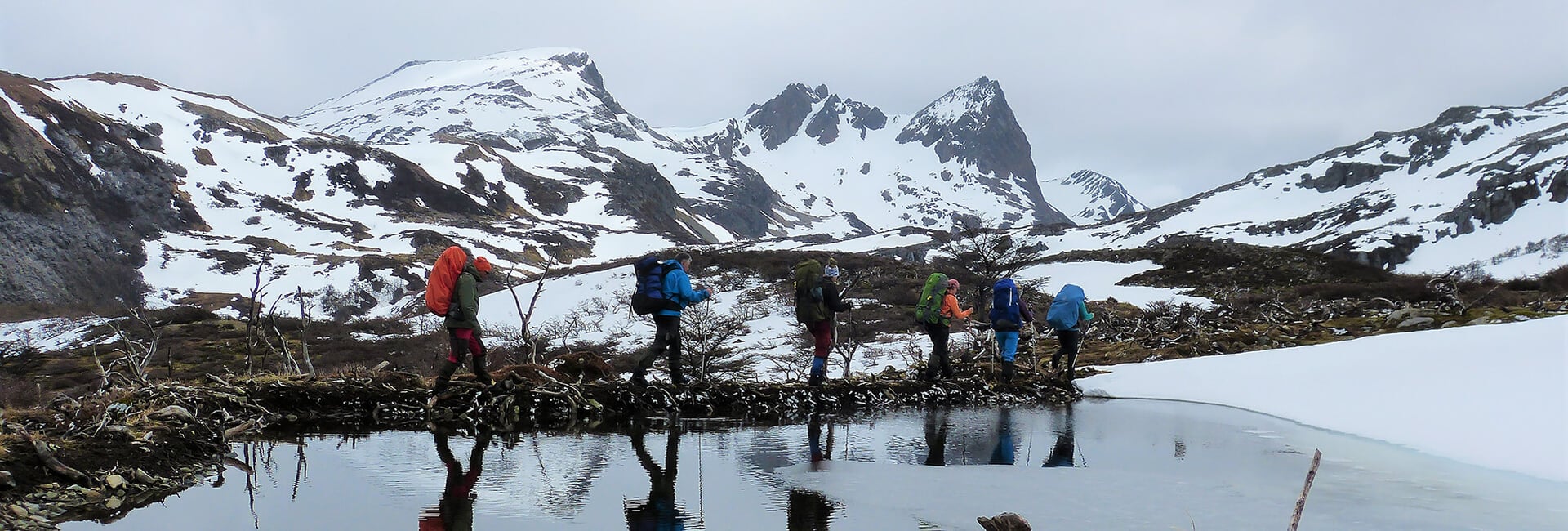 Crossing a beaver dam, Dientes de Navarino Trek